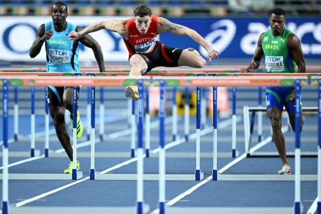 Switzerland's Simon Ehammer (C) competes to finish first ahead of Bahamas' Kendrick Thompson (L) and Brazil's Jose Fernando Ferreira in the men's heptathlon 60 metres hurdles heat 2 during the World Athletics Indoor Championships Kujawy Pomorze 2026 in Torun, Poland on March 21, 2026. (Photo by Kirill KUDRYAVTSEV / AFP)