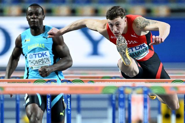 Switzerland's Simon Ehammer (R) competes ahead of Bahamas' Kendrick Thompson in the men's heptathlon 60 metres hurdles heat 2 during the World Athletics Indoor Championships Kujawy Pomorze 2026 in Torun, Poland on March 21, 2026. (Photo by Kirill KUDRYAVTSEV / AFP)