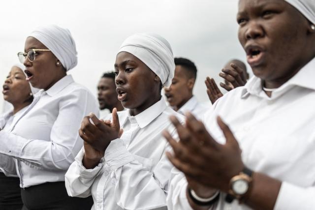 An a cappella choir performs during a ceremony commemorating the Sharpeville Massacre of March 21, 1960, when dozens were killed, at Phelindaba Cemetery in Sharpeville on March 21, 2026. The Sharpeville Massacre occurred on 21 March 1960, when police opened fire on a crowd of people who had assembled outside the police station in the township of Sharpeville in the then Transvaal Province of the then Union of South Africa (today part of Gauteng) to protest against the pass laws. Today South Africa remembers the victims in what has become Human Rights Day. (Photo by ILARIA FINIZIO / AFP)