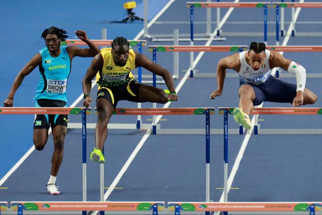 Bahamas' Tahj Brown (L), Jamaica's Demario Prince and Italy's Lorenzo Ndele Simonelli compete in the men's 60 metres hurdles heat 1 during the World Athletics Indoor Championships Kujawy Pomorze 2026 in Torun, Poland on March 21, 2026. (Photo by Wojtek RADWANSKI / AFP)