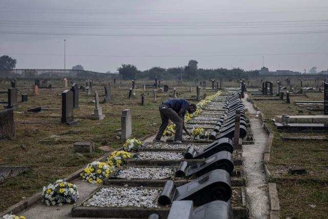A member of the protocol lays flowers to the graves of the dozens killed on March 21, 1960 during what is remembered as the Sharpeville Massacre, at the Phelindaba Cemetery in Sharpeville, on March 21, 2026. The Sharpeville massacre occurred on 21 March 1960, when police opened fire on a crowd of people who had assembled outside the police station in the township of Sharpeville in the then Transvaal Province of the then Union of South Africa (today part of Gauteng) to protest against the pass laws. Today South Africa remembers the victims in what has become Human Rights Day. (Photo by MARCO LONGARI / AFP)