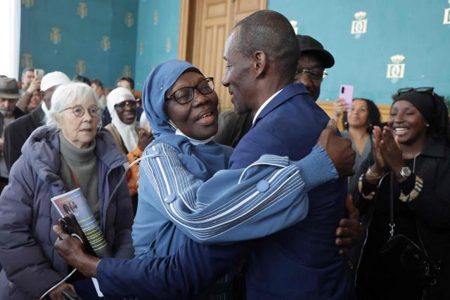 Saint-Denis Mayor Bally Bagayoko (R) is congratulated by his mother ahead of the first session of the newly-elected city council in Saint-Denis, suburb of Paris, on March 21, 2026. (Photo by Ludovic MARIN / AFP)