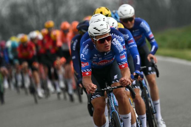 Team Alpecin leads the pack during the Milan - Sanremo one-day classic cycling race, in Pavia, on March 21, 2026. (Photo by Marco BERTORELLO / AFP)