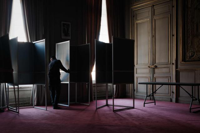 A municipal workers installs voting booths in an ornate room of the Bordeaux city hall in Bordeaux, south-western France on March 21, 2026, ahead of France's second round in the 2026 municipal elections. (Photo by Philippe LOPEZ / AFP)