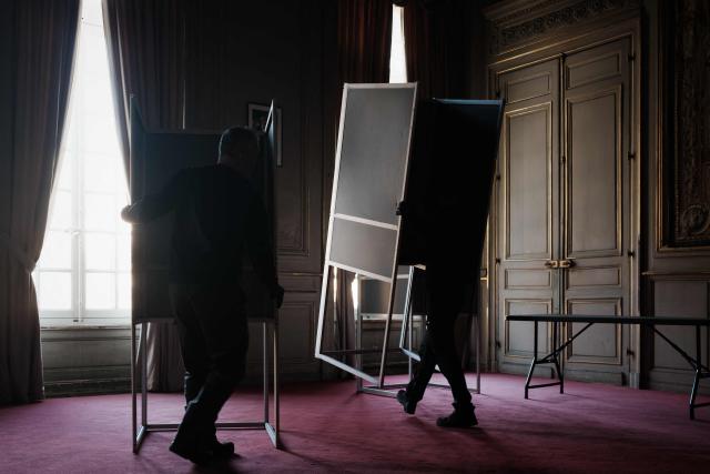 Municipal workers install voting booths in an ornate room of the Bordeaux city hall in Bordeaux, south-western France on March 21, 2026, ahead of France's second round in the 2026 municipal elections. (Photo by Philippe LOPEZ / AFP)
