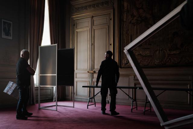 Municipal workers install voting booths in an ornate room of the Bordeaux city hall in Bordeaux, south-western France on March 21, 2026, ahead of France's second round in the 2026 municipal elections. (Photo by Philippe LOPEZ / AFP)