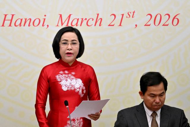 Nguyen Thi Thanh (L), Permanent Vice Chairwoman of the National Election Council, attends a press conference announcing the results of the National Assembly and People's Council elections, at the National Assembly Building in Hanoi on March 21, 2026. (Photo by Nhac NGUYEN / AFP)