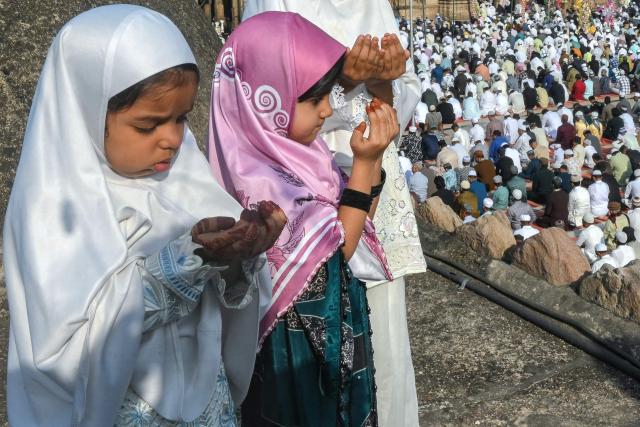 Muslim girls offer Eid al-Fitr prayers, which marks the end of the Islamic holy fasting month of Ramadan, at the Jama Masjid in Ahmedabad on March 21, 2026. (Photo by Shammi MEHRA / AFP)