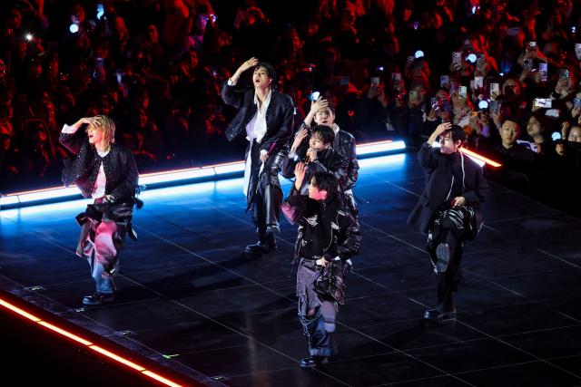 K-pop boy group BTS perform during their concert at Gwanghwamun Square in Seoul on March 21, 2026. South Korean megastars BTS reunited on March 21 for their first show in nearly four years, blowing away enormous crowds in Seoul for a K-pop extravaganza livestreamed to millions more worldwide. (Photo by Kim Hong-Ji / POOL / AFP)