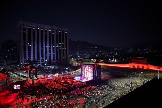 K-pop boy group BTS perform during their concert at Gwanghwamun Square in Seoul on March 21, 2026. South Korean megastars BTS reunited on March 21 for their first show in nearly four years, blowing away enormous crowds in Seoul for a K-pop extravaganza livestreamed to millions more worldwide. (Photo by Kim Hong-Ji / POOL / AFP)