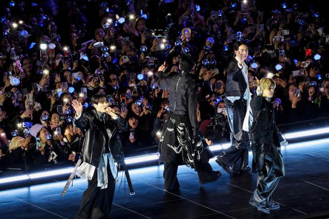 K-pop boy group BTS wave to fans after performing during their concert at Gwanghwamun Square in Seoul on March 21, 2026. South Korean megastars BTS reunite on March 21, for their first show in nearly four years, with an expected 260,000 fans taking over central Seoul for a K-pop extravaganza livestreamed to millions more worldwide. (Photo by Kim Hong-Ji / POOL / AFP)