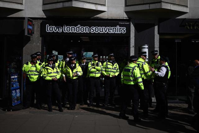 Police officers gather to police a protest march in central London on March 21, 2026, calling for a stop to the bombing of Iran. Britain has authorised the United States to use its bases to strike Iranian sites threatening the Strait of Hormuz shipping lane, the government said Friday. (Photo by Henry NICHOLLS / AFP)