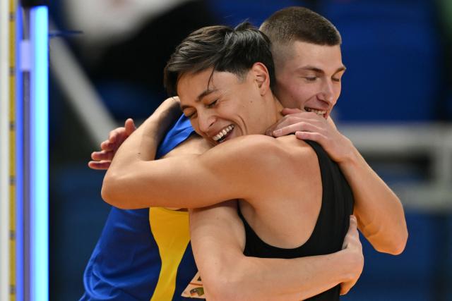 Mexico's Erick Portillo (R) and Ukraine's Oleh Doroshchuk celebrate in the Men's High Jump final during the World Athletics Indoor Championships Kujawy Pomorze 2026 in Torun, Poland on March 21, 2026. (Photo by Andrej ISAKOVIC / AFP)