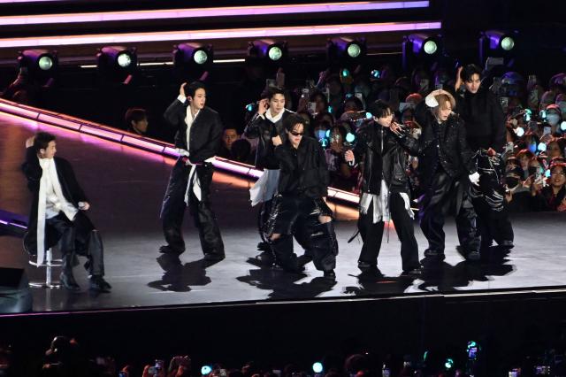 K-pop boy group BTS perform during their concert at Gwanghwamun Square in Seoul on March 21, 2026. South Korean megastars BTS reunite on March 21, for their first show in nearly four years, with an expected 260,000 fans taking over central Seoul for a K-pop extravaganza livestreamed to millions more worldwide. (Photo by KIM Min-Hee / POOL / AFP)