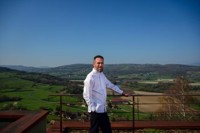 French chef Michael Arnoult, who has just been awarded a third Michelin star, poses at his restaurant Les Morainières in Jongieux, central-eastern France, on March 20, 2026. The calm amid the vineyards of Jongieux in Savoie contrasts with the bustle of the restaurant Les Morainières, where chef Michael Arnoult received no fewer than 250 reservations as soon as his third Michelin star was awarded. (Photo by OLIVIER CHASSIGNOLE / AFP)