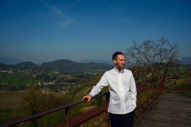 French chef Michael Arnoult, who has just been awarded a third Michelin star, poses at his restaurant Les Morainières in Jongieux, central-eastern France, on March 20, 2026. The calm amid the vineyards of Jongieux in Savoie contrasts with the bustle of the restaurant Les Morainières, where chef Michael Arnoult received no fewer than 250 reservations as soon as his third Michelin star was awarded. (Photo by OLIVIER CHASSIGNOLE / AFP)