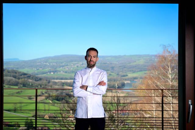 French chef Michael Arnoult, who has just been awarded a third Michelin star, poses at his restaurant Les Morainières in Jongieux, central-eastern France, on March 20, 2026. The calm amid the vineyards of Jongieux in Savoie contrasts with the bustle of the restaurant Les Morainières, where chef Michael Arnoult received no fewer than 250 reservations as soon as his third Michelin star was awarded. (Photo by OLIVIER CHASSIGNOLE / AFP)