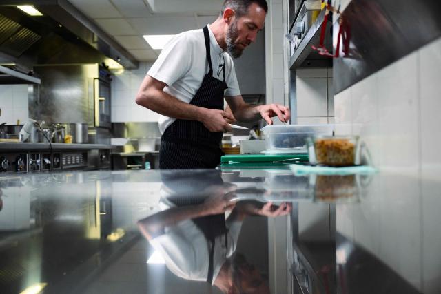 French chef Michael Arnoult, who has just been awarded a third Michelin star, works in the kitchen at his restaurant Les Morainieres in Jongieux, central-eastern France, on March 20, 2026. The calm amid the vineyards of Jongieux in Savoie contrasts with the bustle of the restaurant Les Morainières, where chef Michael Arnoult received no fewer than 250 reservations as soon as his third Michelin star was awarded. (Photo by OLIVIER CHASSIGNOLE / AFP)