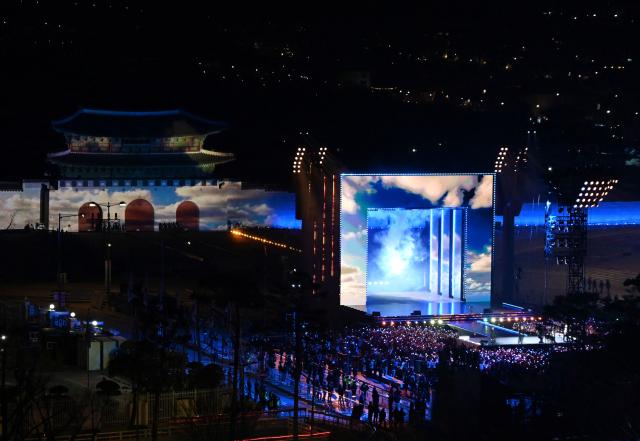 K-pop boy group BTS perform during their concert at Gwanghwamun Square in Seoul on March 21, 2026. South Korean megastars BTS reunite on March 21, for their first show in nearly four years, with an expected 260,000 fans taking over central Seoul for a K-pop extravaganza livestreamed to millions more worldwide. (Photo by KIM Min-Hee / POOL / AFP)