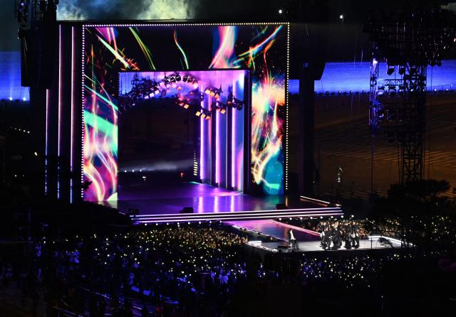 K-pop boy group BTS perform during their concert at Gwanghwamun Square in Seoul on March 21, 2026. South Korean megastars BTS reunite on March 21, for their first show in nearly four years, with an expected 260,000 fans taking over central Seoul for a K-pop extravaganza livestreamed to millions more worldwide. (Photo by KIM Min-Hee / POOL / AFP)