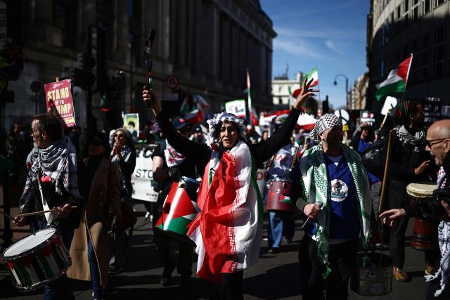 Protesters take part in a protest march in central London on March 21, 2026, calling for the bombing of Iran to stop. Britain has authorised the United States to use its bases to strike Iranian sites threatening the Strait of Hormuz shipping lane, the government said Friday. (Photo by Henry NICHOLLS / AFP)