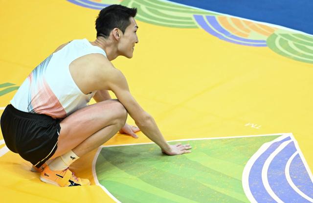 South Korea's Woo Sanghyeok reacts after his jump in the Men's High Jump final during the World Athletics Indoor Championships Kujawy Pomorze 2026 in Torun, Poland on March 21, 2026. (Photo by Kirill KUDRYAVTSEV / AFP)