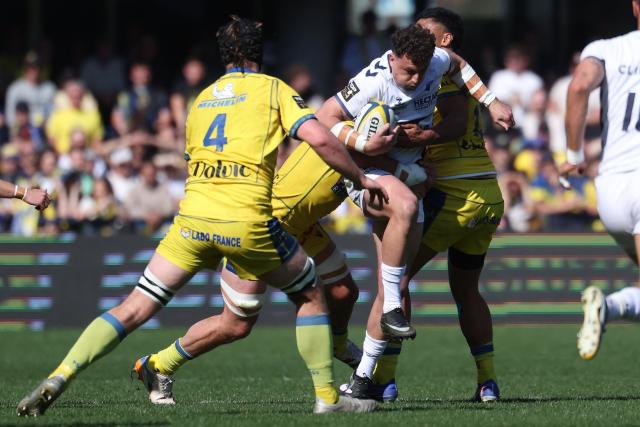 Montpellier’s Australian full-back Tom Banks (C) is tackled by Clermont's Argentine flanker Marcos Kremer (L) and Clermont's Australian centre Irae Simone during the French Top14 rugby union match between ASM Clermont Auvergne and Montpellier Herault Rugby at the Stade Marcel-Michelin in Clermont-Ferrand, central France on March 21, 2026. (Photo by Alex MARTIN / AFP)