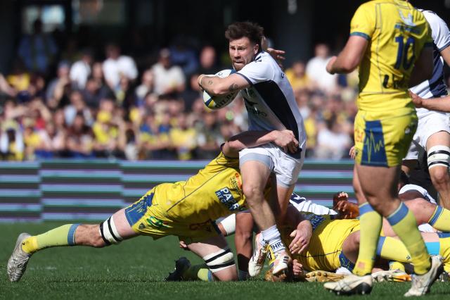Montpellier’s Scottish scrum-half Ali Price (C) is tackled by Clermont's French lock Thibault Lanen during the French Top14 rugby union match between ASM Clermont Auvergne and Montpellier Herault Rugby at the Stade Marcel-Michelin in Clermont-Ferrand, central France on March 21, 2026. (Photo by Alex MARTIN / AFP)