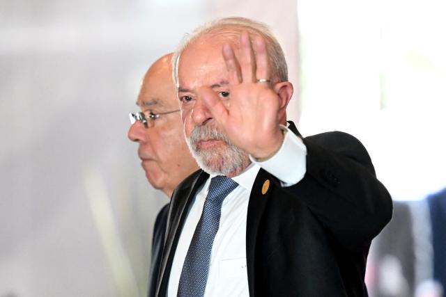 Brazil's President Luiz Inacio Lula da Silva waves upon arrival for the X Summit of Heads of State and Government, within the framework of the CELAC-Africa High-Level Forum in Bogota on March 21, 2026. (Photo by RAUL ARBOLEDA / AFP)