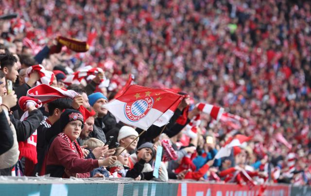 Bayern Munich fans cheer during the German first division Bundesliga football match between FC Bayern Munich and Union Berlin in Munich, southern Germany, on March 21, 2026. (Photo by Karl-Josef HILDENBRAND / AFP) / DFL REGULATIONS PROHIBIT ANY USE OF PHOTOGRAPHS AS IMAGE SEQUENCES AND/OR QUASI-VIDEO