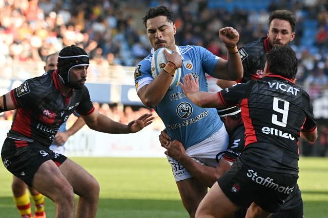 Perpignan's Australian wing Jordan Petaia is tackled during the French Top 14 rugby union match between USA Perpignan and Lyon OU at the Aime-Giral stadium in Perpignan, south-western France, on March 21, 2026. (Photo by Matthieu RONDEL / AFP)