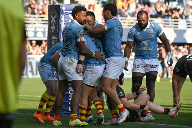 USAP players celebrate after scoring a try during the French Top 14 rugby union match between USA Perpignan and Lyon OU at the Aime-Giral stadium in Perpignan, south-western France, on March 21, 2026. (Photo by Matthieu RONDEL / AFP)