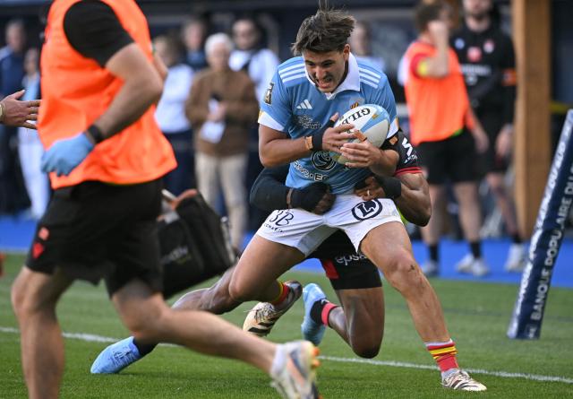 Perpignan's French centre Diego Mascarenc is tackled during the French Top 14 rugby union match between USA Perpignan and Lyon OU at the Aime-Giral stadium in Perpignan, south-western France, on March 21, 2026. (Photo by Matthieu RONDEL / AFP)