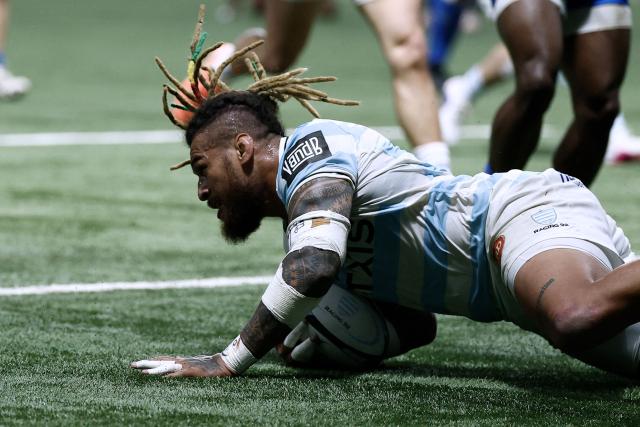 Racing 92' Fijian Nathan Hughes scores a try during the French Top 14 rugby union match between Racing 92 and Castres Olympique at the Paris La Défense Arena in Nanterre, on March 21, 2026. (Photo by Kenzo TRIBOUILLARD / AFP)