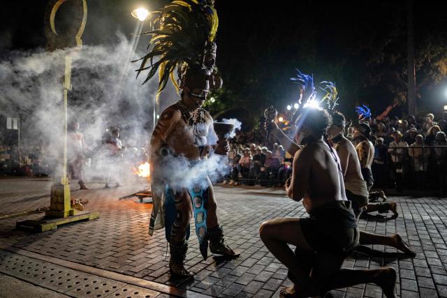 Players prepare with a ritual ceremony for a Mayan ballgame show in Merida, Yucatan state, Mexico, on March 20, 2026. The Mayan ballgame dates back 3,500 years, making it the first organized sport in history. It is played with a heavy 3-kilogram solid rubber ball that is struck with the hips. The traditional game is still played in tournaments in seven countries: Mexico, the United States, Guatemala, Belize, Honduras, El Salvador and Panama. (Photo by Carl de Souza / AFP)