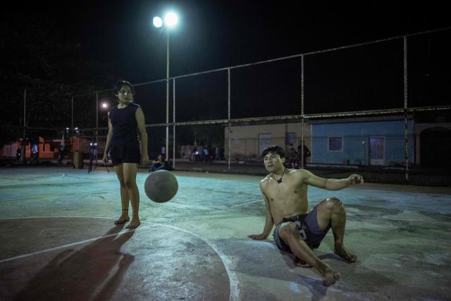 Angel Jesus Be Chi (R), captain of the Mexican Mayan ballgame team Mayawayak, plays with a traditional ball during a practice session in San Pedro Chimay, Yucatan state, Mexico, on March 20, 2026. The Mayan ballgame dates back 3,500 years, making it the first organized sport in history. It is played with a heavy 3-kilogram solid rubber ball that is struck with the hips. The traditional game is still played in tournaments in seven countries: Mexico, the United States, Guatemala, Belize, Honduras, El Salvador and Panama. (Photo by Carl de Souza / AFP)