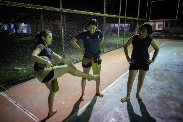 Young women from the Mexican Mayan ballgame team Mayawayak take part in a practice session in San Pedro Chimay, Yucatan state, Mexico, on March 20, 2026. The Mayan ballgame dates back 3,500 years, making it the first organized sport in history. It is played with a heavy 3-kilogram solid rubber ball that is struck with the hips. The traditional game is still played in tournaments in seven countries: Mexico, the United States, Guatemala, Belize, Honduras, El Salvador and Panama. (Photo by Carl de Souza / AFP)