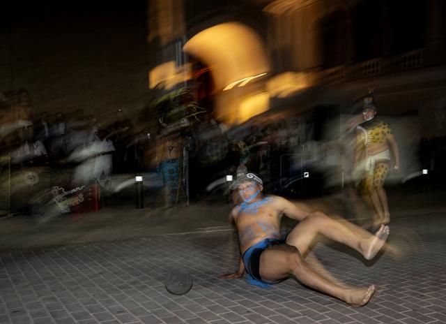 Players participate in a Mayan ballgame show in Merida, Yucatan state, Mexico, on March 20, 2026. The Mayan ballgame dates back 3,500 years, making it the first organized sport in history. It is played with a heavy 3-kilogram solid rubber ball that is struck with the hips. The traditional game is still played in tournaments in seven countries: Mexico, the United States, Guatemala, Belize, Honduras, El Salvador and Panama. (Photo by Carl de Souza / AFP)