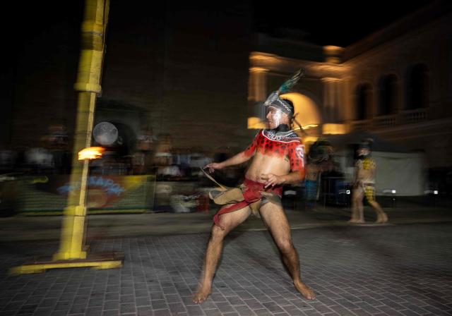 Players participate in a Mayan ballgame show in Merida, Yucatan state, Mexico, on March 20, 2026. The Mayan ballgame dates back 3,500 years, making it the first organized sport in history. It is played with a heavy 3-kilogram solid rubber ball that is struck with the hips. The traditional game is still played in tournaments in seven countries: Mexico, the United States, Guatemala, Belize, Honduras, El Salvador and Panama. (Photo by Carl de Souza / AFP)