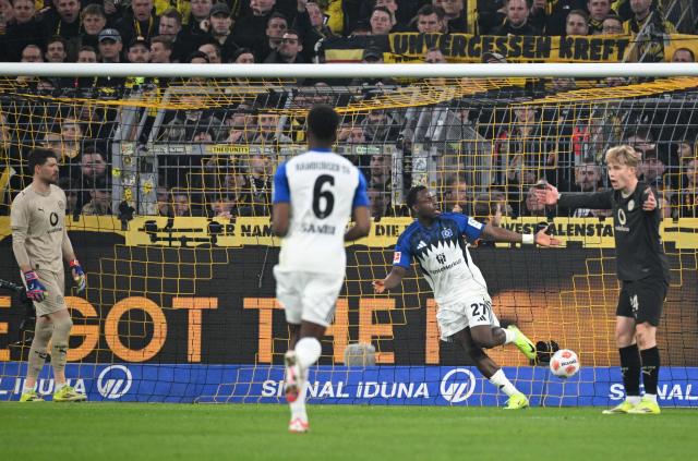 Hamburg's Nigerian froward #27 Philip Otele (2nd R) celebrates his 0-1 during the German first division Bundesliga football match between Borussia Dortmund and HSV Hamburg in Dortmund, western Germany, on March 21, 2026. (Photo by UWE KRAFT / AFP) / DFL REGULATIONS PROHIBIT ANY USE OF PHOTOGRAPHS AS IMAGE SEQUENCES AND/OR QUASI-VIDEO