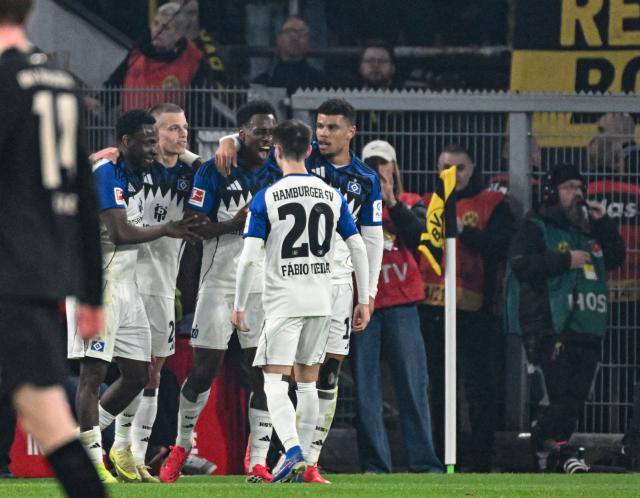 Hamburg's team celebrates the 0-2 during the German first division Bundesliga football match between Borussia Dortmund and HSV Hamburg in Dortmund, western Germany, on March 21, 2026. (Photo by UWE KRAFT / AFP) / DFL REGULATIONS PROHIBIT ANY USE OF PHOTOGRAPHS AS IMAGE SEQUENCES AND/OR QUASI-VIDEO
