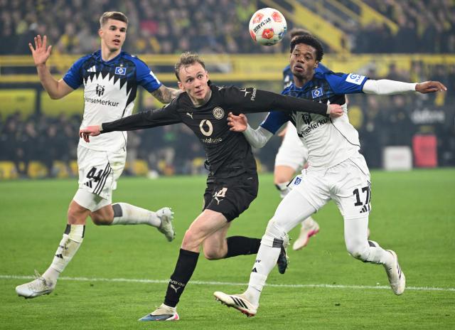 Hamburg's Croatian defender #44 Luka Vuskovic, Dortmund's German forward #14 Maximilian Beier and Hamburg's Comorian defender #17 Warmed Omari vie for the ball during the German first division Bundesliga football match between Borussia Dortmund and HSV Hamburg in Dortmund, western Germany, on March 21, 2026. (Photo by UWE KRAFT / AFP) / DFL REGULATIONS PROHIBIT ANY USE OF PHOTOGRAPHS AS IMAGE SEQUENCES AND/OR QUASI-VIDEO