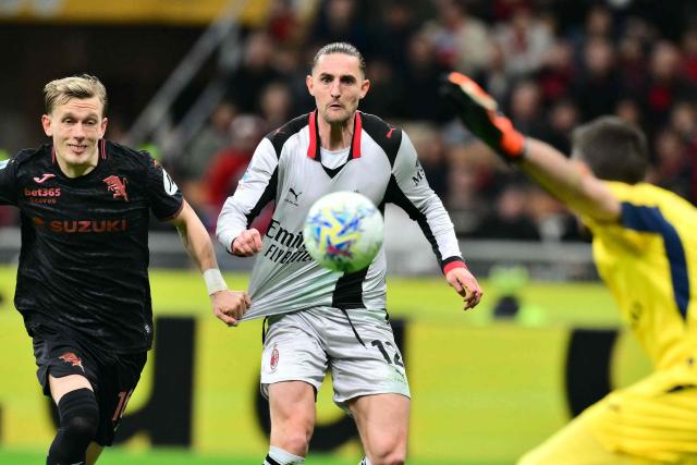 AC Milan's French midfielder  #12 Adrien Rabiot prepares to score his team's second goal against Torino's Italian goalkeeper #01 Alberto Paleari during the Italian Serie A football match between AC Milan and Torino at San Siro stadium in Milan, northern Italy, on March 21, 2026. (Photo by Stefano RELLANDINI / AFP)