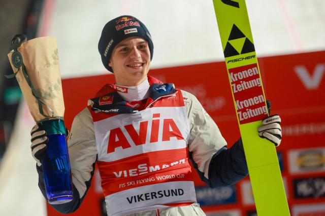 First placed Austria's Stephan Embacher celebrates on the podium after the men's ski flying event of the FIS Ski Jumping World Cup in Vikersund, Norway on March 21, 2028. (Photo by Trond R Teigen / NTB / AFP) / Norway OUT