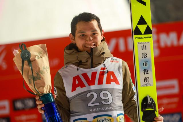 Second placed Japan's Tomofumi Naito celebrates on the podium after the men's ski flying event of the FIS Ski Jumping World Cup in Vikersund, Norway on March 21, 2028. (Photo by Trond R Teigen / NTB / AFP) / Norway OUT