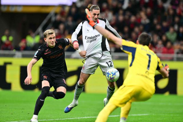 AC Milan's French midfielder  #12 Adrien Rabiot scores his team's second goal during the Italian Serie A football match between AC Milan and Torino at San Siro stadium in Milan, northern Italy, on March 21, 2026. (Photo by Stefano RELLANDINI / AFP)