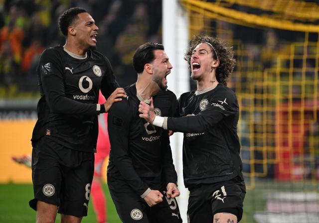Dortmund's Portuguese forward #21 Fabio Silva (R) celebrates his 2-2 with Dortmund's German midfielder #08 Felix Nmecha (L) and Dortmund's Algerian defender #05 Ramy Bensebaini during the German first division Bundesliga football match between Borussia Dortmund and HSV Hamburg in Dortmund, western Germany, on March 21, 2026. (Photo by UWE KRAFT / AFP) / DFL REGULATIONS PROHIBIT ANY USE OF PHOTOGRAPHS AS IMAGE SEQUENCES AND/OR QUASI-VIDEO