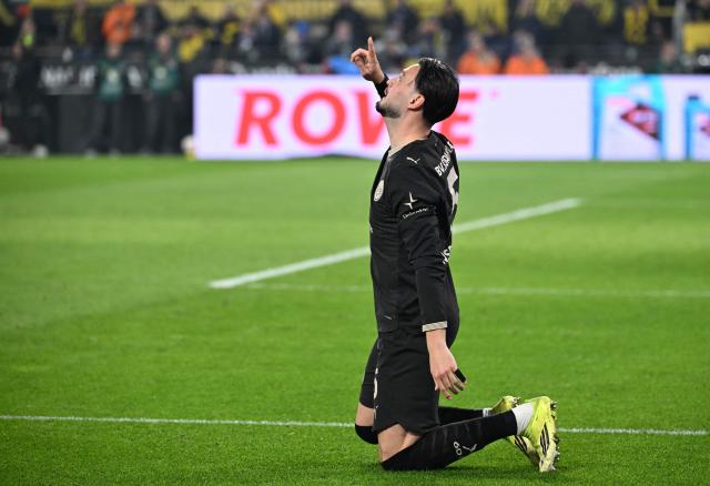 Dortmund's Algerian defender #05 Ramy Bensebaini celebrates a goal during the German first division Bundesliga football match between Borussia Dortmund and HSV Hamburg in Dortmund, western Germany, on March 21, 2026. (Photo by UWE KRAFT / AFP) / DFL REGULATIONS PROHIBIT ANY USE OF PHOTOGRAPHS AS IMAGE SEQUENCES AND/OR QUASI-VIDEO
