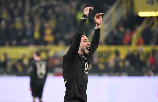 Dortmund's Algerian defender #05 Ramy Bensebaini celebrates a goal during the German first division Bundesliga football match between Borussia Dortmund and HSV Hamburg in Dortmund, western Germany, on March 21, 2026. (Photo by UWE KRAFT / AFP) / DFL REGULATIONS PROHIBIT ANY USE OF PHOTOGRAPHS AS IMAGE SEQUENCES AND/OR QUASI-VIDEO