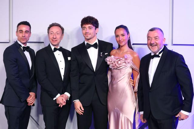 French-Luxembourgish journalist and TV and radio host Stephane Bern (2nd L), his companion Yori Bailleres (L), Monegasque Formula One pilot Charles Leclerc (3rd L),  his wife Alexandra (2nd R) and Canal + programmes director Gerald-Brice Viret (R) pose upon arrival for the 70th edition of the "Bal de la Rose" (Rose Ball) event at the Monte-Carlo Sporting Club in Monaco, on March 21, 2026. Created by Princess Grace of Monaco in 1954, The Rose Ball is one of the major charity events in Monaco, and benefits the Princess Grace Foundation. (Photo by Valery HACHE / AFP) / ==== NO TABLOIDS WEB & PRINT, NO DAILY MAIL, NO DAILY MAIL GROUP, NO VOICI, NO CLOSER ====
